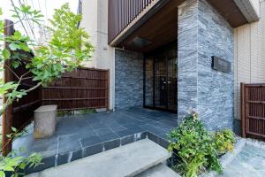 a patio with a bench in front of a building at リブレ芳斉 #102 in Housai +19 photos