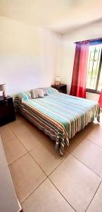 ein großes Bett in einem Zimmer mit Fenster in der Unterkunft Casa Safari en La Paisanita, Alta Gracia in Alta Gracia
