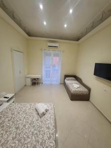 a bedroom with two beds and a table and a television at Re Umberto 311 in Naples