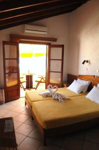 a hotel room with two beds with towels on them at Despina Studios in Kokkari