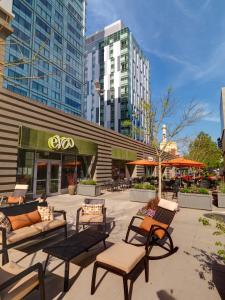 a patio with chairs and tables in front of a building at Global Luxury Suites at Kendall West in Cambridge