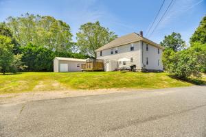 a white house with a porch and a driveway at Wakefield Escape Walk to Downtown and Near Beaches! in South Kingstown