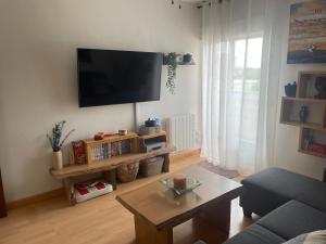 a living room with a flat screen tv on the wall at La Casa delSastre in Frómista