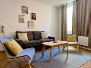 a living room with a couch and a coffee table at Chez Isa et Thomas in Narbonne +14 photos