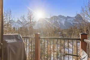 a balcony with a view of a snow covered mountain at C303 Hidden Gem with MTN andCreek View, Quiet and Private in Canmore