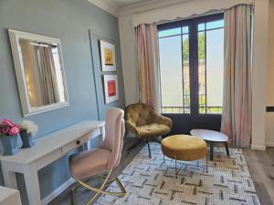 a living room with a desk and chairs and a window at Lazy Olives in Tongeren