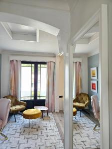 a living room with two chairs and a table at Lazy Olives in Tongeren