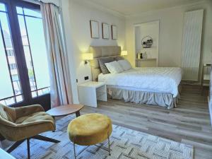 a bedroom with a bed and a couch and a chair at Lazy Olives in Tongeren