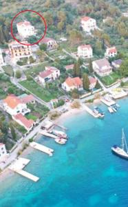 an island with a house and boats in the water at Apartments kod Ilje i Seke in Prvić Šepurine