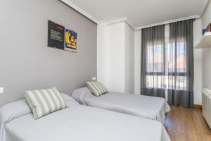 A bed or beds in a room at BaruHaus Nido Valencia de don Juan