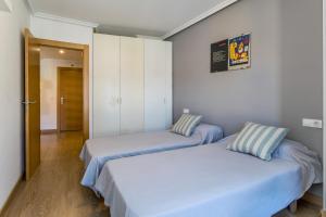 A bed or beds in a room at BaruHaus Nido Valencia de don Juan