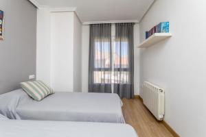 A bed or beds in a room at BaruHaus Nido Valencia de don Juan