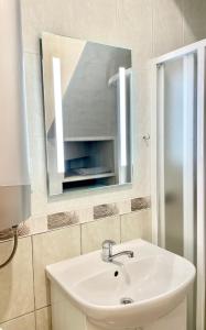 a bathroom with a sink and a mirror at Neringaholiday Apartamentai in Juodkrantė +16 photos