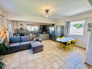a living room with a couch and a table at Airfenos - Athens Riviera in Anavyssos