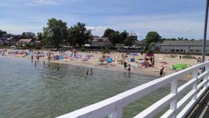 a group of people on a beach near the water at Angel Sea Hill Apartment in Mechelinki