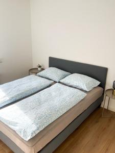 a bed with two pillows on it in a bedroom at Lovely Billund Apartment by KIRIJA in Billund