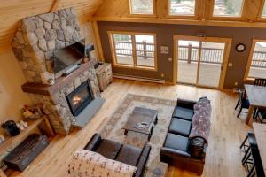 an overhead view of a living room with a stone fireplace at Spacious Cabin 10 Mi to Sunday River Skiing! in Bethel
