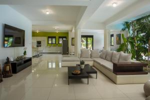 a living room with a couch and a table at Villa Melia in Koskinou