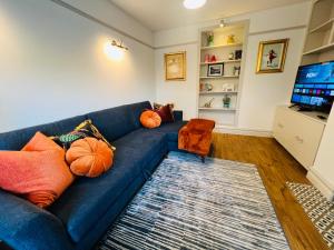 a blue couch in a living room with pumpkins at Luxurious 5Star Retreat on Westports Main Street in Westport