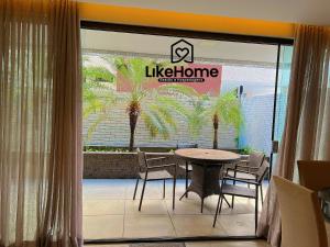 a restaurant with a table and chairs and a sign at Eco Summer Tambaú, LikeHome in Tambaú