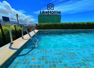 a swimming pool with blue water in front of a building at Eco Summer Tambaú, LikeHome in Tambaú