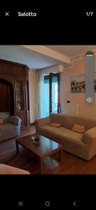 a living room with a couch and a coffee table at Roses house in Porto San Giorgio