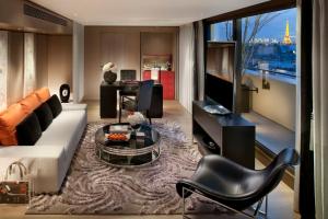 a living room with a couch and a table at Mandarin Oriental, Paris in Paris