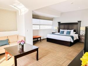 a hotel room with a bed and a couch at Hotel Stadium in Le&oacute;n