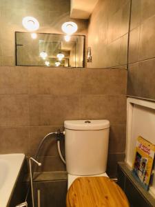 a bathroom with a toilet with a sink and a mirror at Appartement très haut avec Piscine, sauna, salle de sport et solarium in Paris