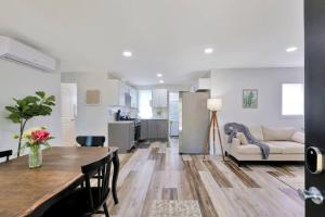 a kitchen and living room with a table and a couch at Tiny Home Baby Friendly in Rantoul