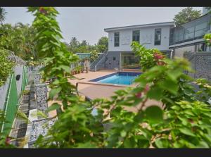 a house with a swimming pool in the backyard at The Mayrock Hotel in Abuja