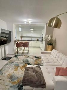 a living room with a white couch and a table at Nice area 5 minutes from Paris in Suresnes