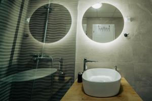 a bathroom with a sink and a shower with a mirror at Eyebee apartments in Ohrid +27 photos
