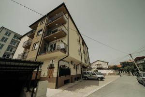 a building with a car parked in front of it at Eyebee apartments in Ohrid