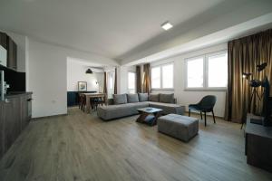 a living room with a couch and a table at Eyebee apartments in Ohrid