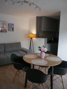 a living room with a table with chairs and a couch at Free Garage in the Center-Delicia 4 ApartHotel in Sibiu