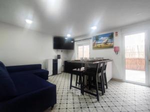 a living room with a blue couch and a kitchen at Seventy House By Furabeach in Furadouro