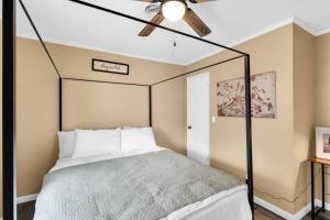 a bedroom with a bed with a ceiling fan at Small cozy ranch in Rantoul