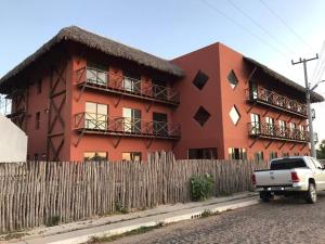 a truck parked in front of a red building at Studio 311 BobZ Concept in Barrinha +4 photos
