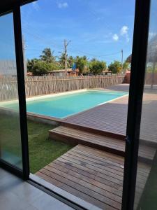 a view of a swimming pool from a window at Studio 311 BobZ Concept in Barrinha