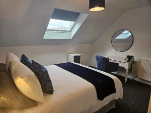 a bedroom with a bed and a desk and a window at Cosy at the castle in Carrickfergus