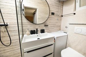a bathroom with a sink and a mirror at New, close to the beach apartment with terrace, grill, parking, 2-rooms in Trogir +44 photos