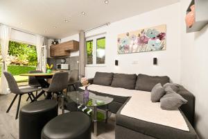 a living room with a couch and a table at New, close to the beach apartment with terrace, grill, parking, 2-rooms in Trogir