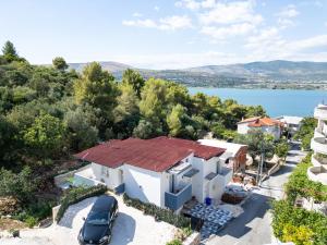 an aerial view of a house with a car at New, close to the beach apartment with terrace, grill, parking, 2-rooms in Trogir