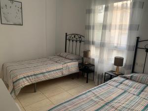 Postel nebo postele na pokoji v ubytování Arcoiris Paradise A 300 metros de la playa ,piscina y parque infantil