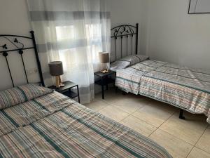 Postel nebo postele na pokoji v ubytování Arcoiris Paradise A 300 metros de la playa ,piscina y parque infantil