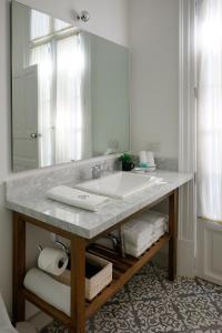 La salle de bains est pourvue d'un lavabo et d'un grand miroir. dans l'établissement Casa Goliana La Roma, à Mexico