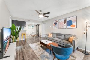 a living room with a couch and a tv at SoCo Chic Apartment Suites Close to Downtown in Austin