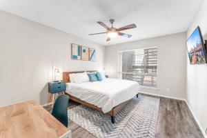 a bedroom with a bed and a ceiling fan at SoCo Chic Apartment Suites Close to Downtown in Austin +30 photos