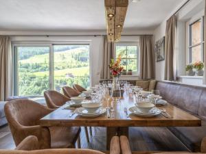 a dining room with a wooden table and chairs at Alpen Villa Danica in Mühlbach am Hochkönig